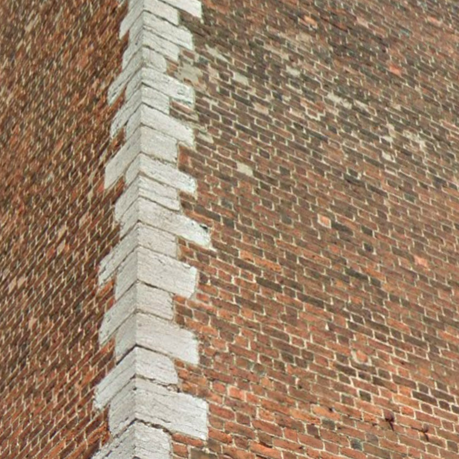 Narożnik budynku z cegieł z widocznym wiązaniem