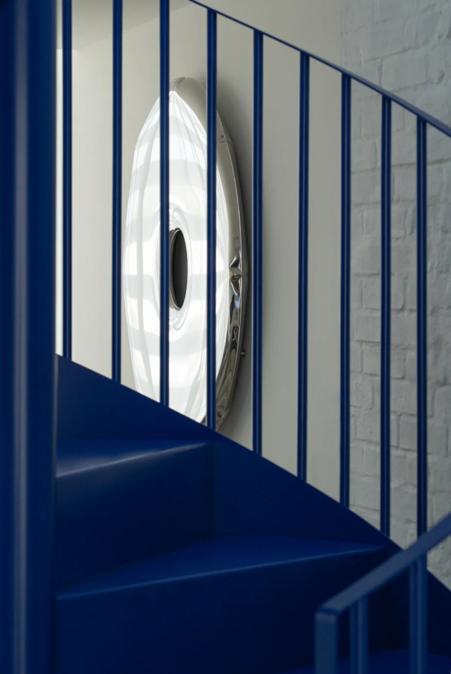 Detail of the circular wall decoration visible through the balustrade spindles.